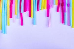 vibrant background of multicolored plastic straws, copy space photo