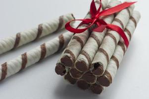 Chocolate vafer sticks on white background photo