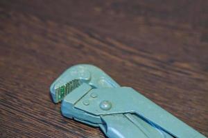 gas wrench on wooden table photo