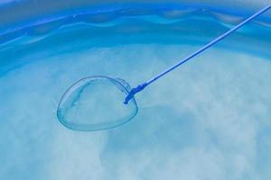 cleaning of Garden Swimming Pool . Skimmer net close up photo