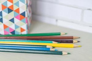 colorful pencils on wooden table photo