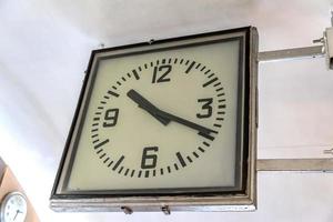 old vintage style square clock hanging on the wall photo