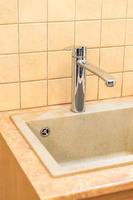 Stainless steel kitchen faucet and sink with tile photo