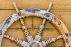 old wooden Handwheel on wooden background photo