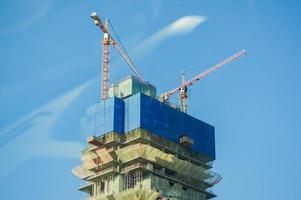 lift cranes building a new residential building photo