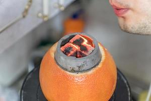 preparation of home made hookah with grapefruit photo