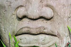 closeup of a Big head statue made of stone photo