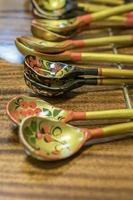 Khokhloma spoons on wooden table photo