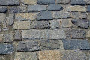 granite stone pavement texture. Abstract background of old cobble stone pavement closeup. photo