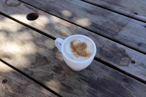 Hot and strong coffee is poured into a cup. photo