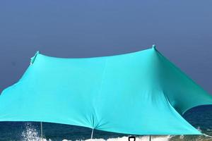 Tent for rest on the shores of the Mediterranean Sea. photo