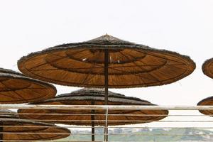 Umbrella for shelter from the sun on the city beach. photo