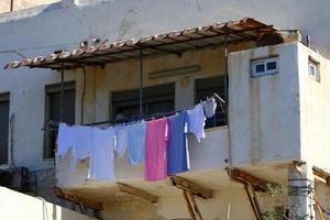 Outside the window, laundry is being dried on a rope on the facade of the building. photo