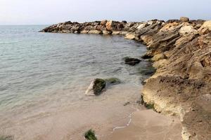 Breakwater on the city beach for protection from high sea waves. photo