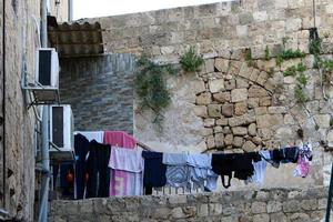 Outside the window, laundry is being dried on a rope on the facade of the building. photo