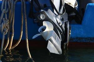 Motor and propeller of a motorboat. photo