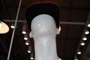 A mannequin stands on a showcase in a store. photo