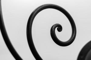 Close up view of iron decorative curved elements on white background photo