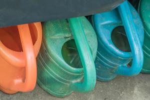 multicolored plastic cans in a row photo