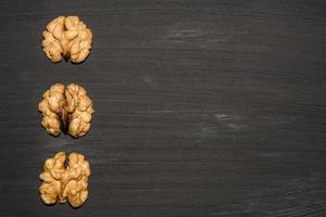 walnuts on black background. Top view with copy space for your text photo