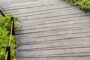 Closeup of wooden bridge in a park during summer photo