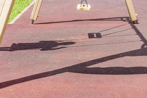 Blurry shadows of a girl on a swing photo