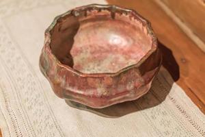 vintage empty metal bowl on wooden table photo