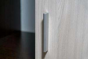 wardrobe door. Closeup of wooden door with metal handle photo