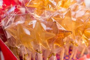 closeup of colorful lollipops in star shape in a shop photo