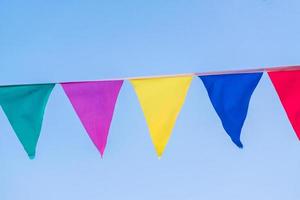 colorful flag garland against blue sky photo