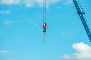 arrow and hook of the crane againsy blue sky photo