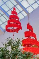 red xmas tree and garland hanging on ceiling closeup photo