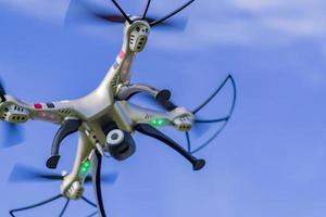 flying drone with remote control against blue sky background. photo