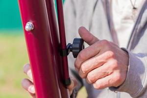 Close up of man hand adjusting heght of metal construction photo