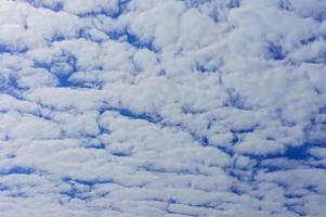 blue sky with fluffy clouds background photo