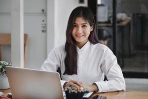 new normal, a businesswoman useing  computer to work for a company Via the internet on your desk at home. photo