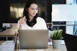 Female employees are working at home through computers to maintain social distancing to reduce the spread of coronavirus. photo