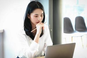 Female employees are working at home through computers to maintain social distancing to reduce the spread of coronavirus. photo
