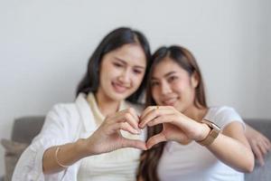 lgbtq, lgbt concept, homosexuality, two Asian women posing happy together and showing love for each other while being together photo