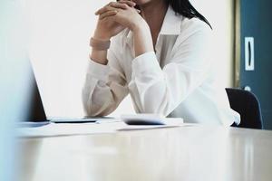 Female employees are working at home through computers to maintain social distancing to reduce the spread of coronavirus. photo