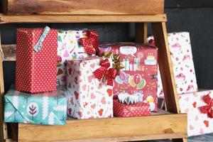 Lots of gift boxes put on a wooden shelf for Christmas. photo