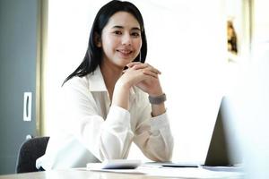 Female employees are working at home through computers to maintain social distancing to reduce the spread of coronavirus. photo