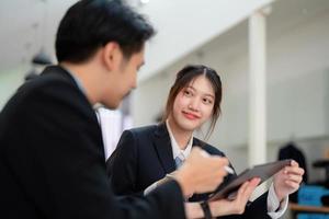 Asian portrait of people working together on a new project to analyze budgets and manage investment risks in today's profit boosting for marketing in the office room photo