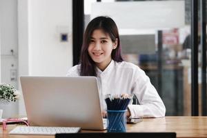 new normal, a businesswoman useing  computer to work for a company Via the internet on your desk at home. photo