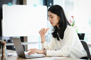 Female employees are working at home through computers to maintain social distancing to reduce the spread of coronavirus. photo