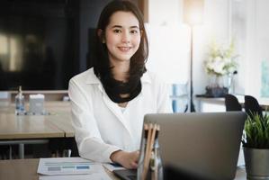 Female employees are working at home through computers to maintain social distancing to reduce the spread of coronavirus. photo