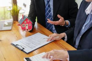 Guarantees, mortgages, signing, interest on loans, real estate agents are making agreements with customers to buy houses and land and sign contract documents photo