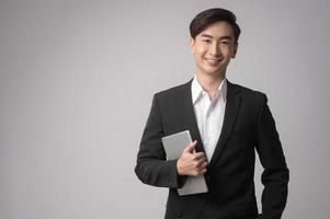 Young businessman wearing  suit over white background studio photo