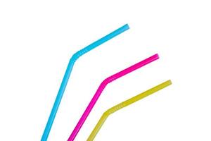 blue, pink and yellow straws for cocktails and other drinks isolated on white background photo