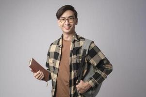 Portrait of an Asian university student over white background studio, education concept. photo